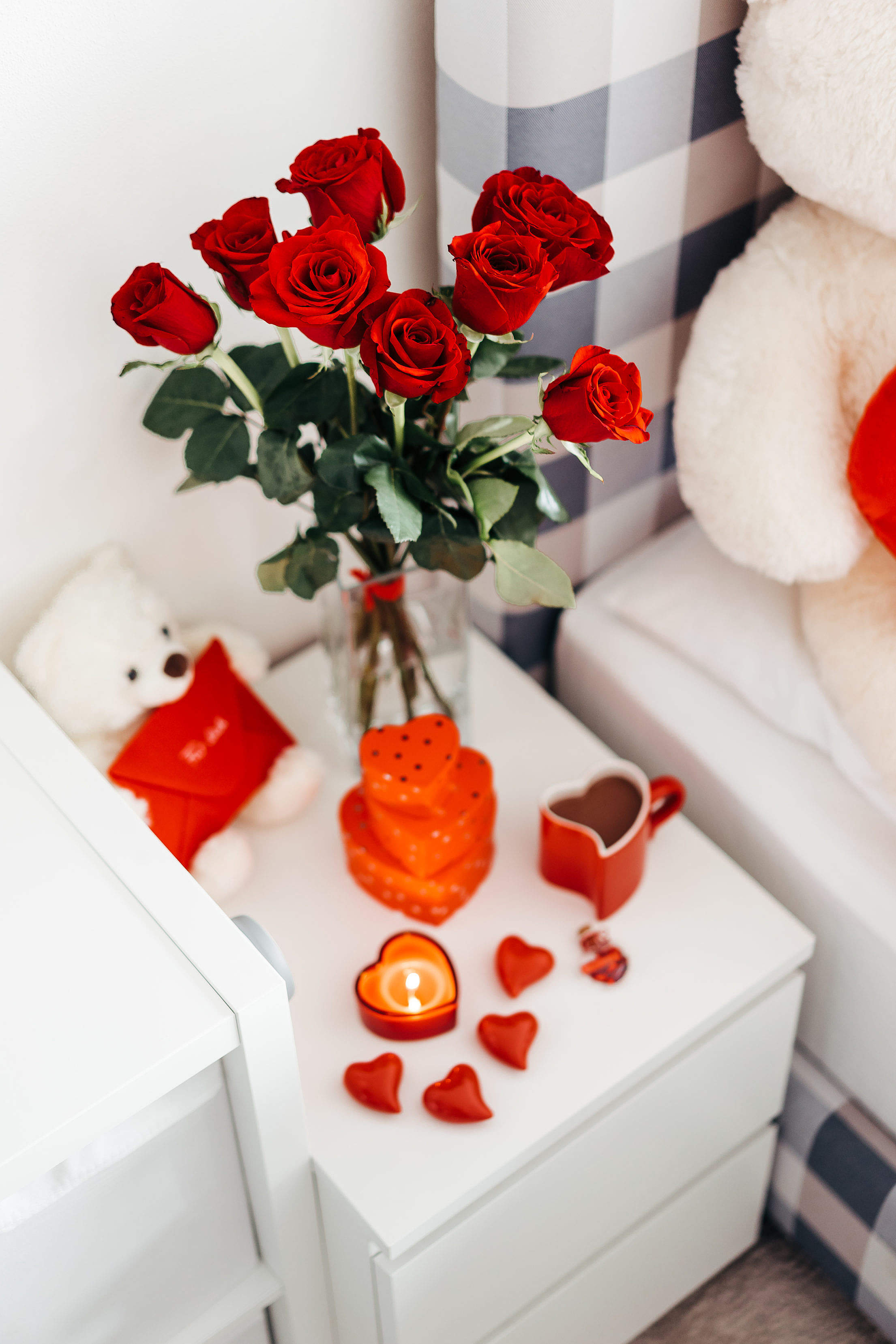 A Bouquet of Red Roses And Other Romantic Gifts on a Bedside Table Free Stock Photo