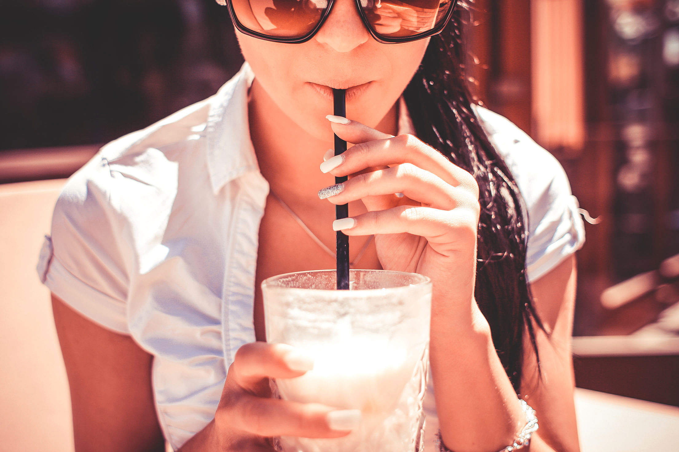 A Girl Drinking Milkshake Drink in Caffe Free Stock Photo