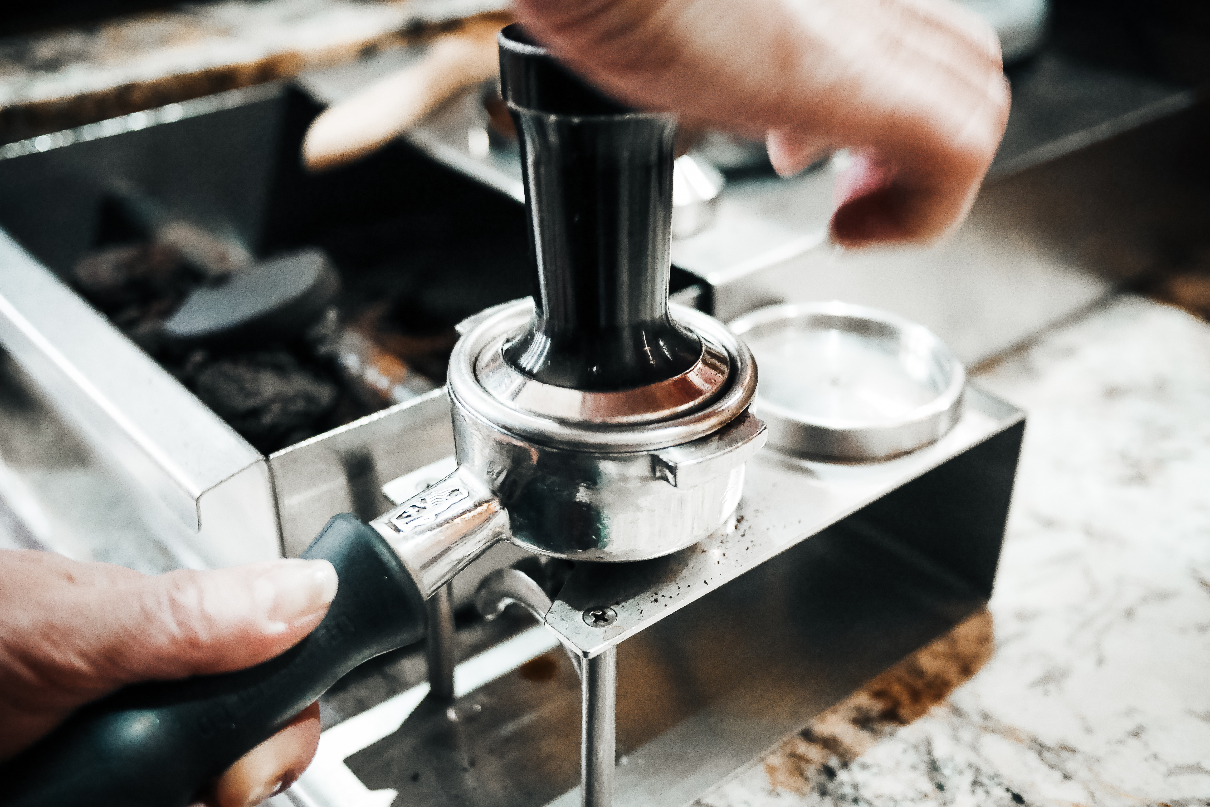 Pressing Ground Coffee in the Cafe Shop 