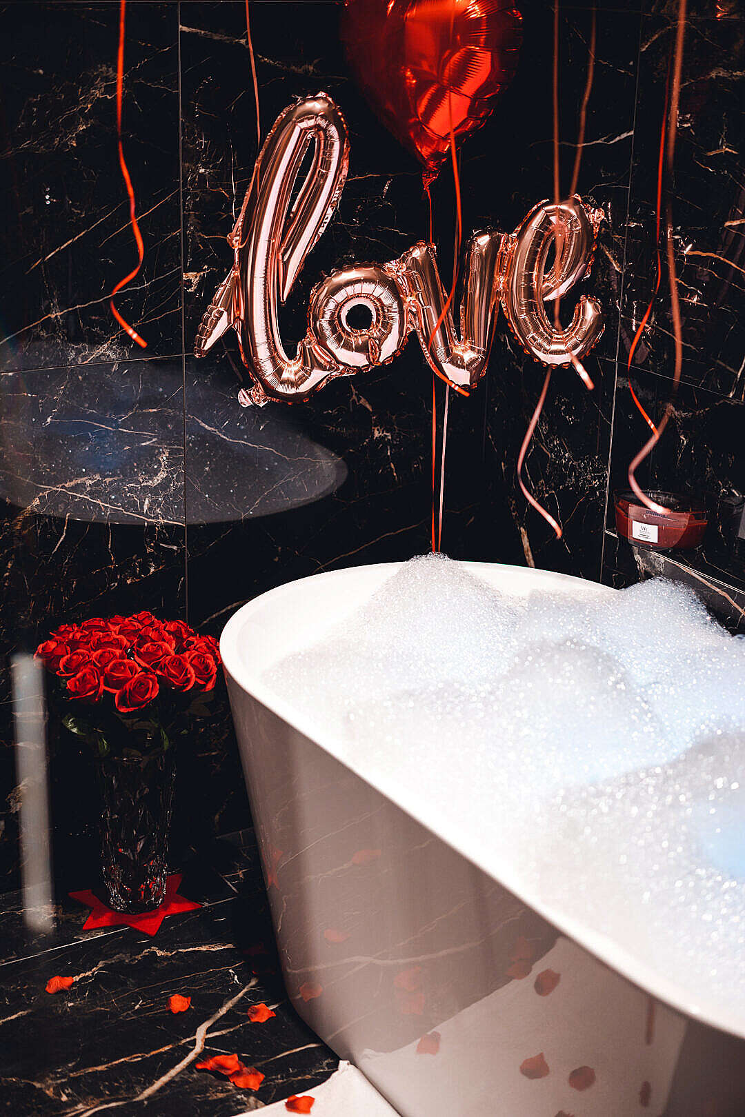 Download Bathtub Full of Foam in Luxury Bathroom with Roses and Love Balloon FREE Stock Photo