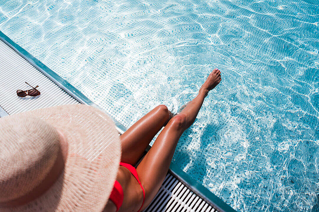 Download Beautiful Bikini Woman Relaxing by the Luxury Pool FREE Stock Photo