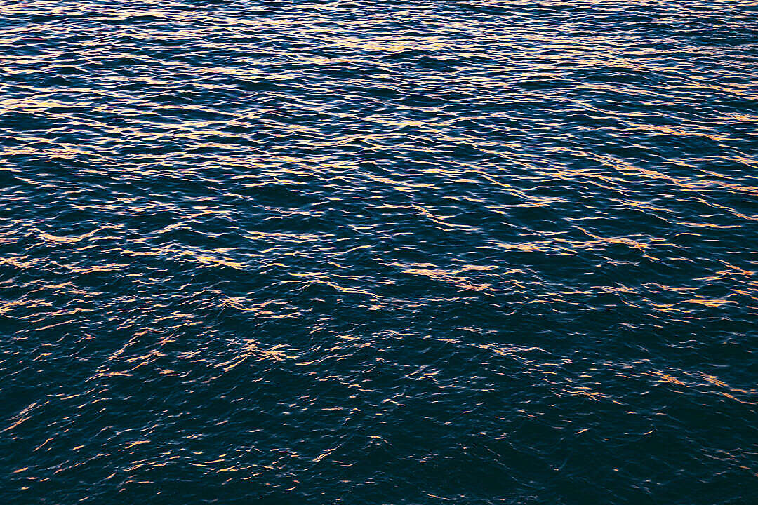 Download Beautiful Calm Sea Surface During Sunset FREE Stock Photo