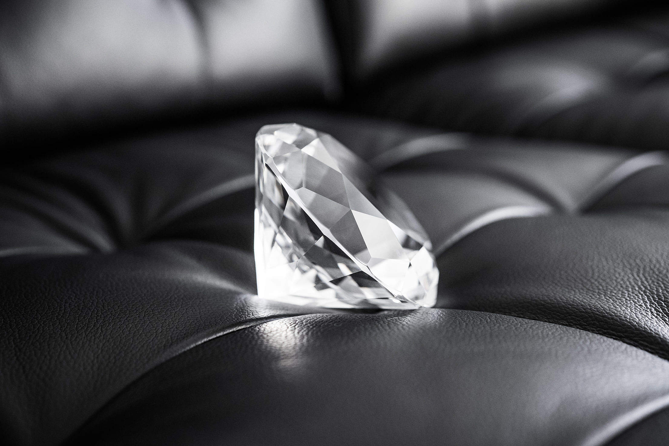 Big Glass Diamond Crystal on Black Leather Sofa Free Stock Photo