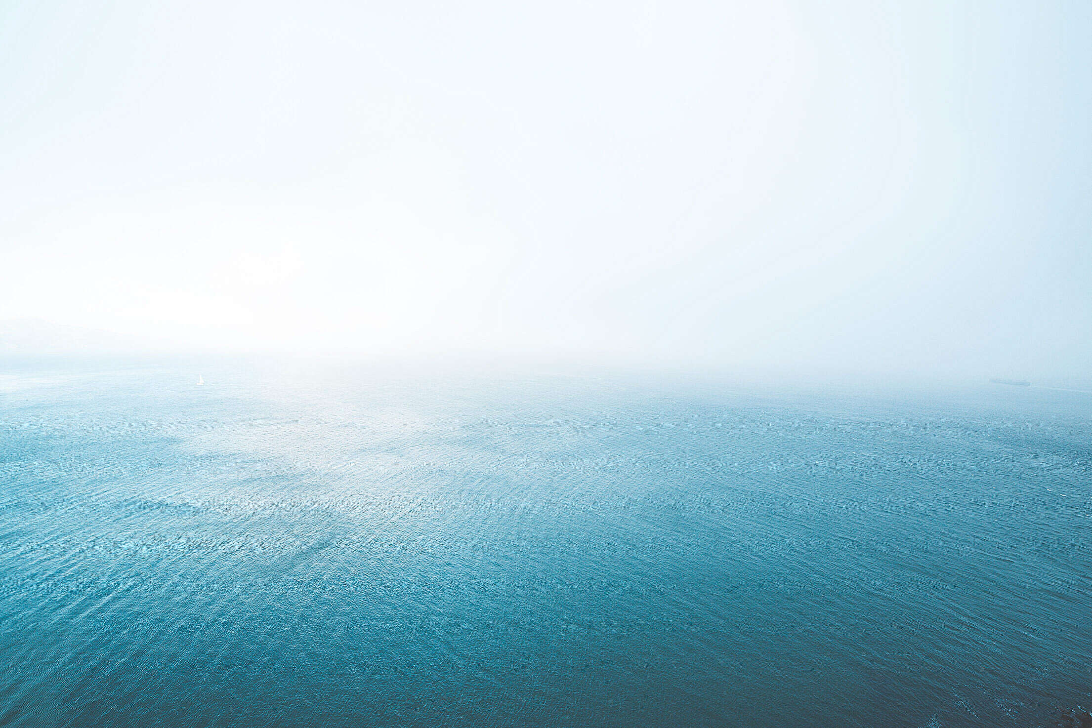 Blue Endless Ocean in Fog Free Stock Photo