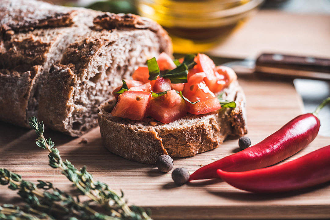 Bread with Tomatoes and Basil on The Chopping Board