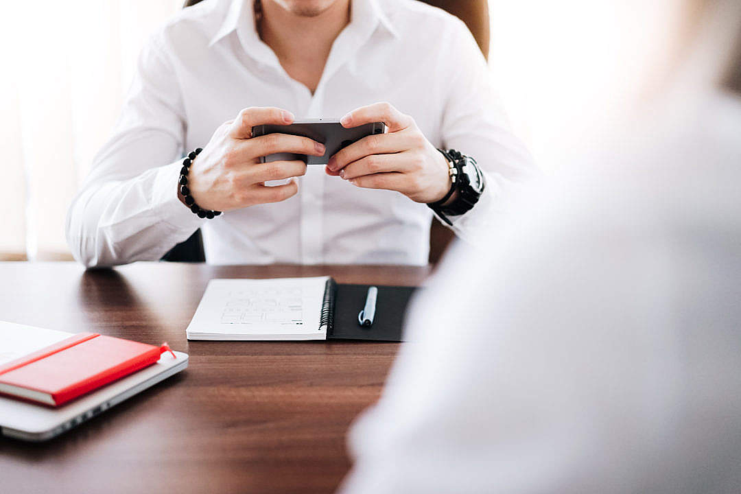 Business Man Working on His Smartphone in The Office