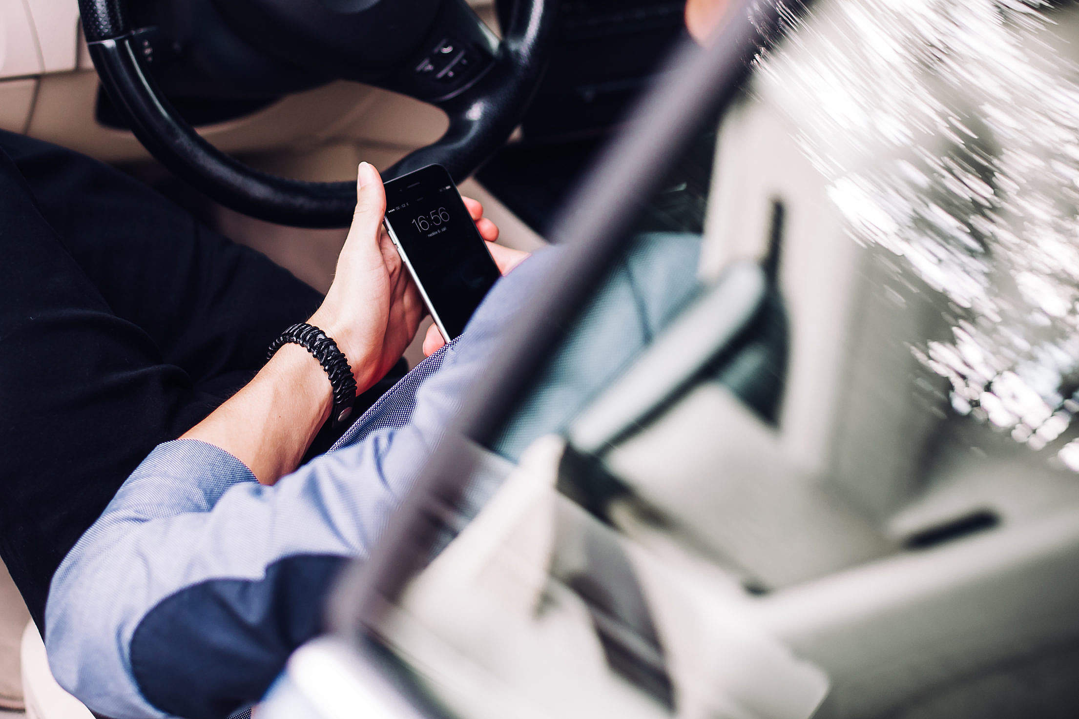 Business Manager Using His Phone in a Car Free Stock Photo