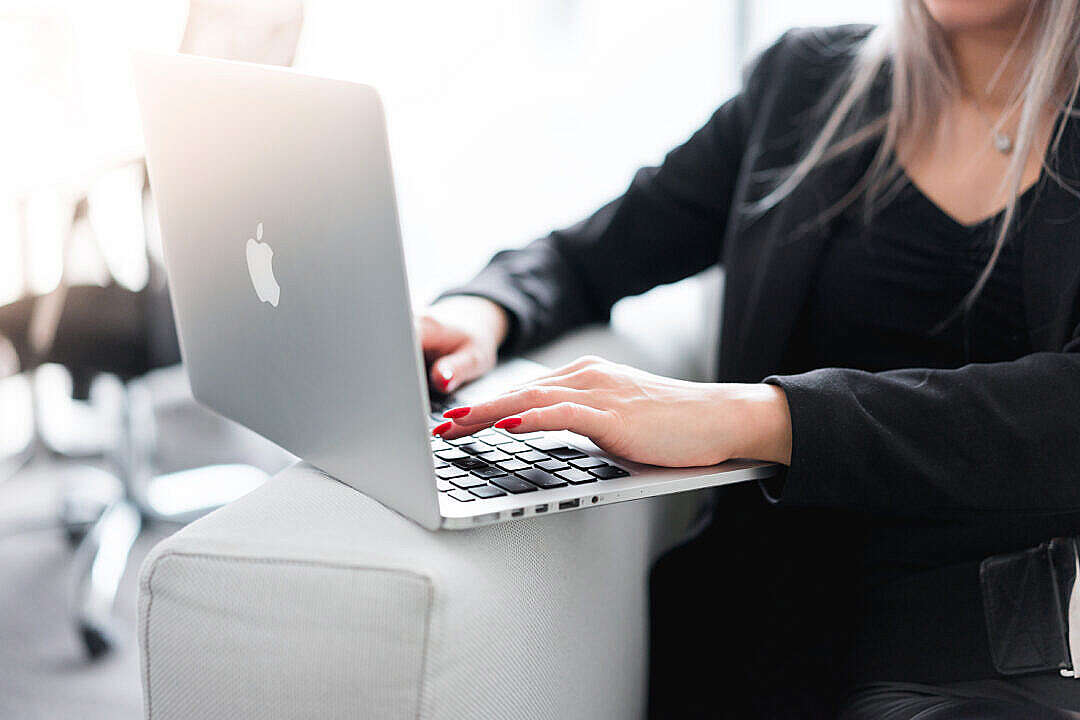 Business Woman Using Her Laptop on a Sofa