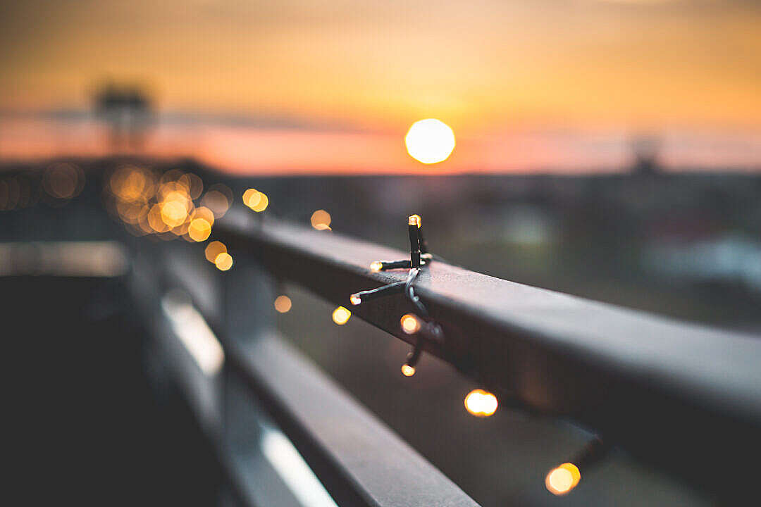 Download Christmas Lights Bokeh Against Sunset FREE Stock Photo