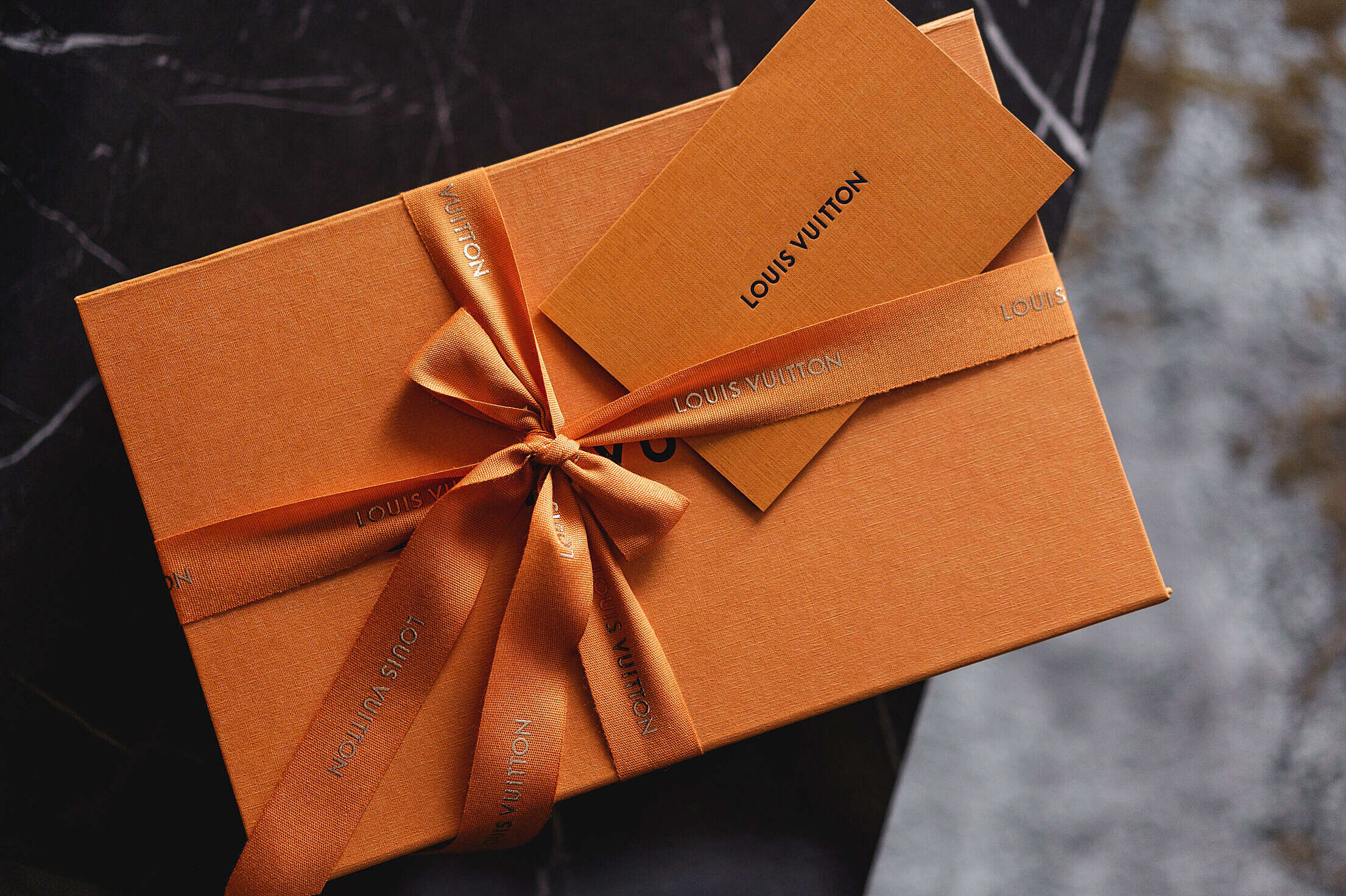 Classic Famous Louis Vuitton Orange Product Box Packaging with a Bow Free  Stock Photo
