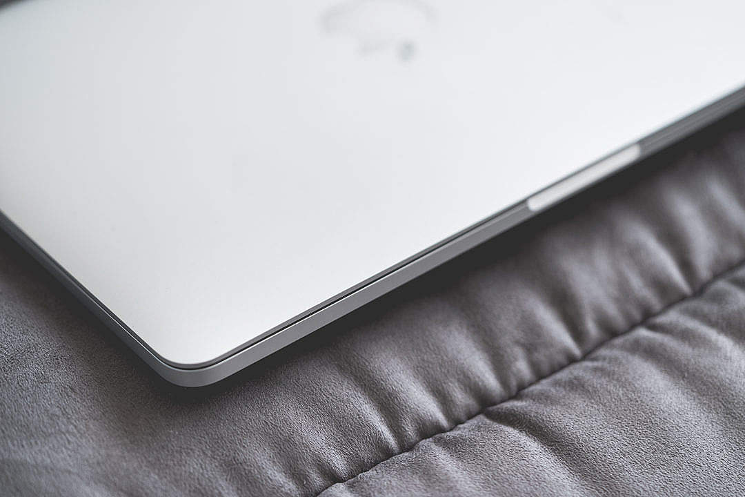 Download Closed Macbook Laptop on a Sofa #2 FREE Stock Photo