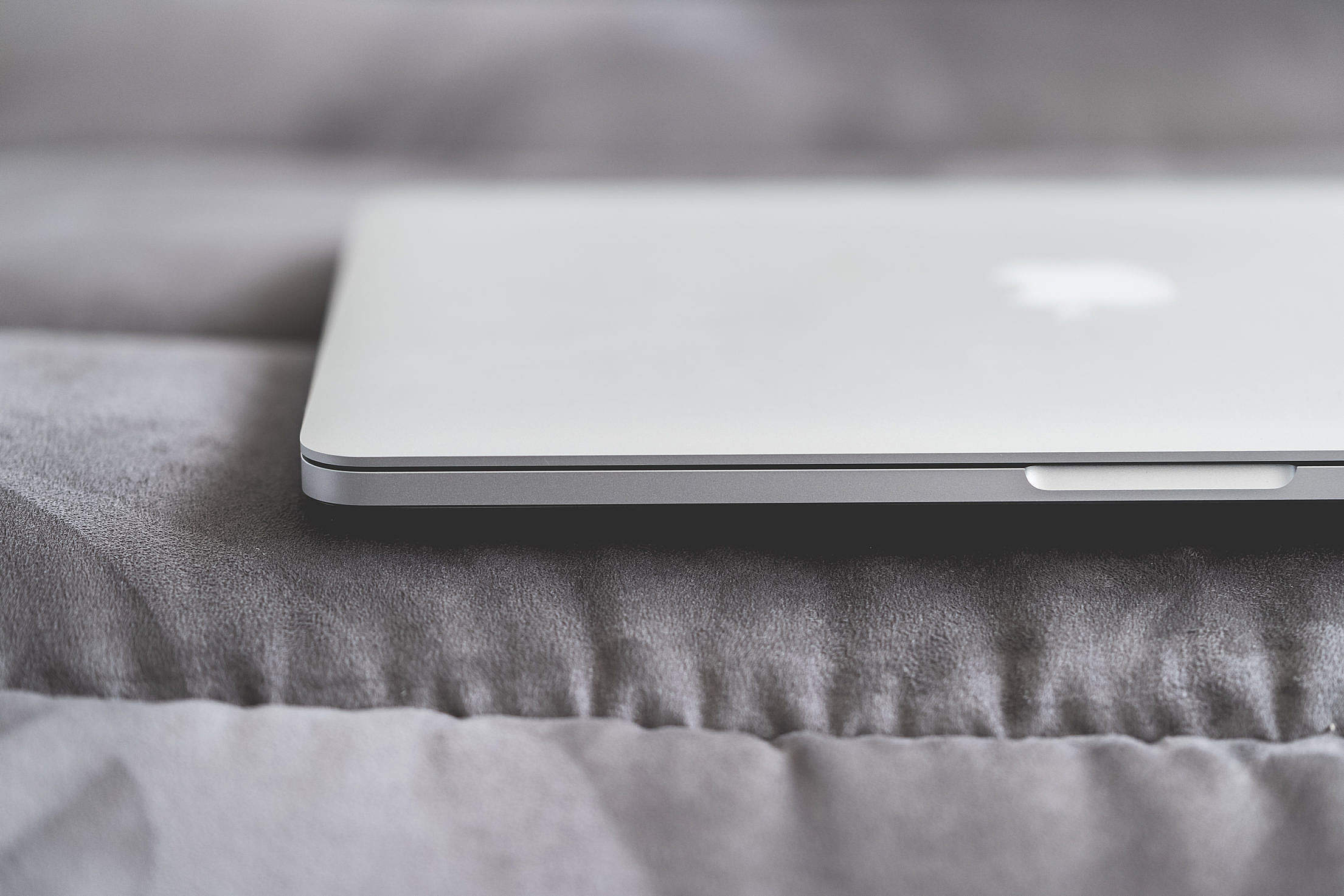 Closed Macbook Laptop on a Sofa Free Stock Photo | picjumbo