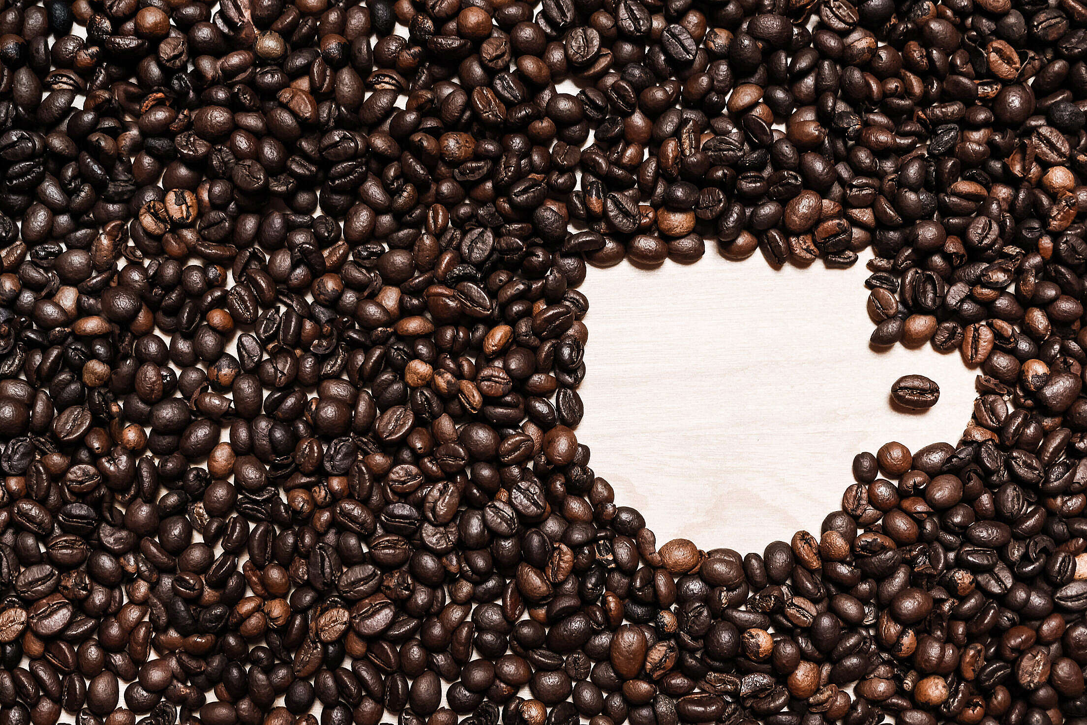 Coffee Cup Shape in Coffee Beans Free Stock Photo