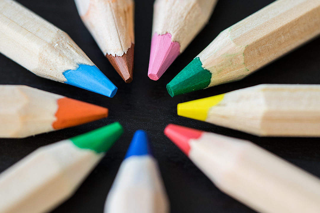 Colored Pencils in a Circle on a Black Desk