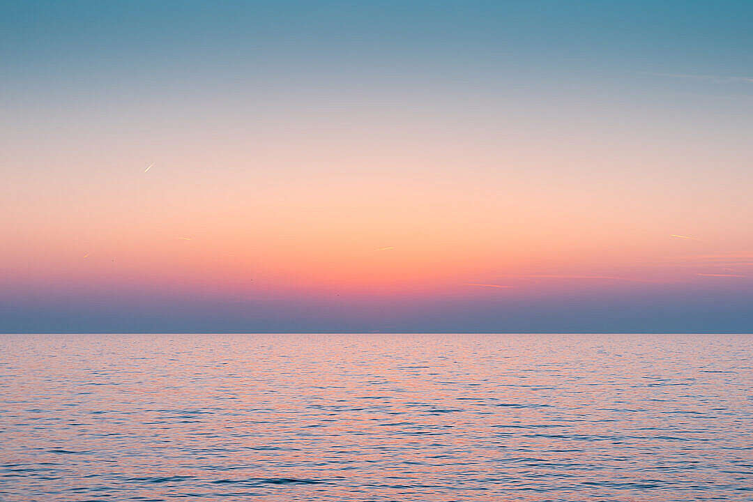 Download Colorful Dawn Sky Above The Calm Sea Horizon FREE Stock Photo