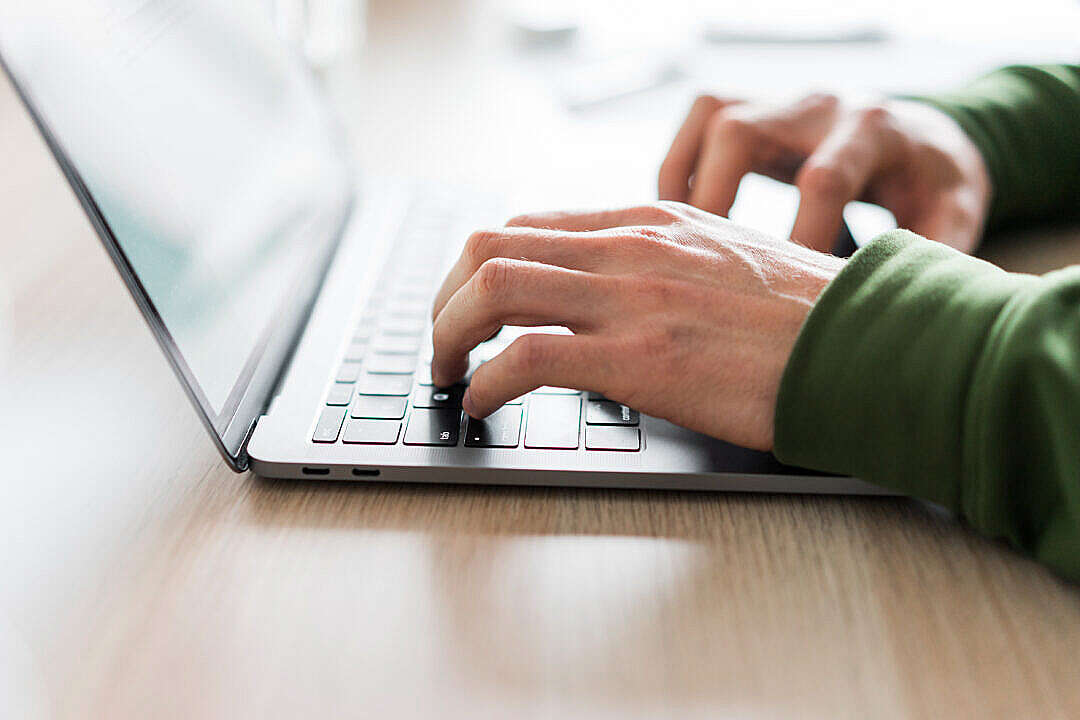 Copywriter Writing on His Modern Laptop Close Up