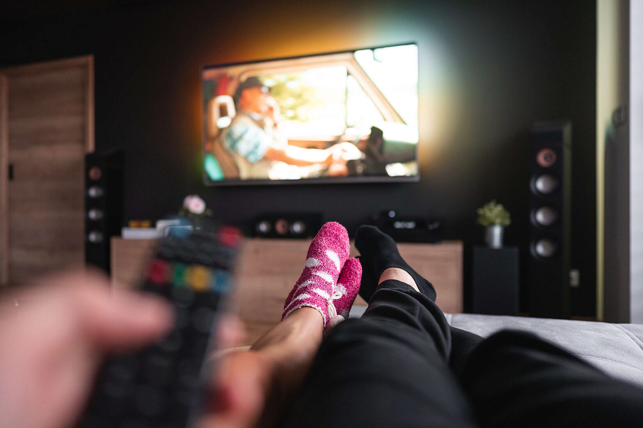 Couple Lying on a Sofa and Watching Movies Free Stock Photo