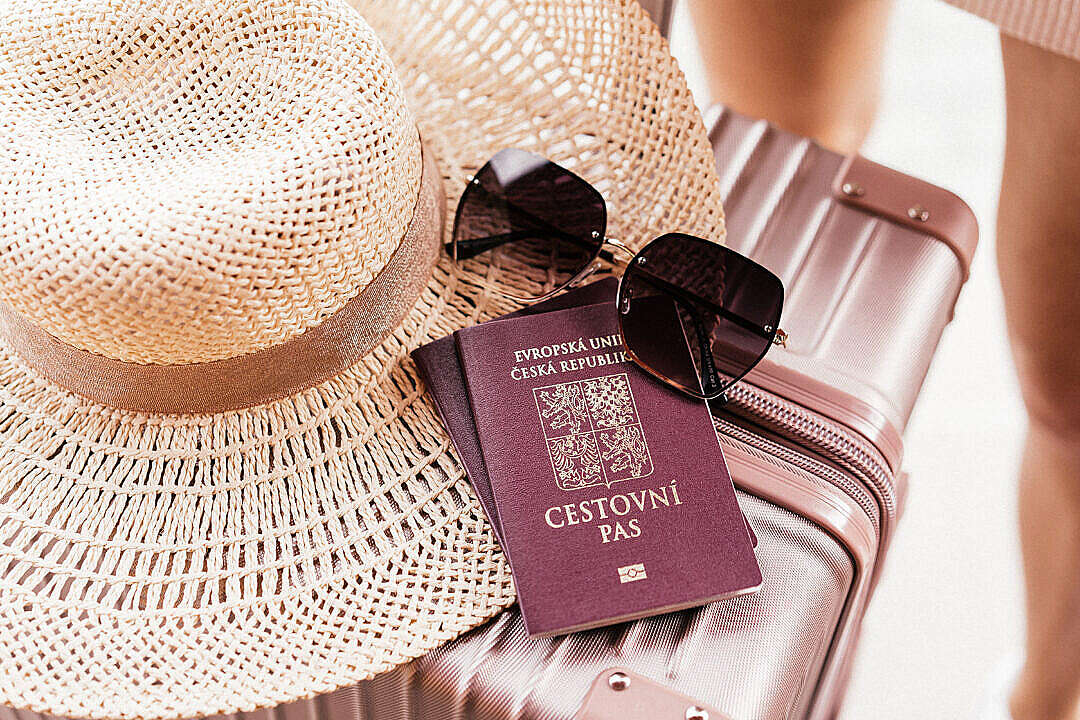 Czech Passport with Sunglasses and Hat on a Suitcase