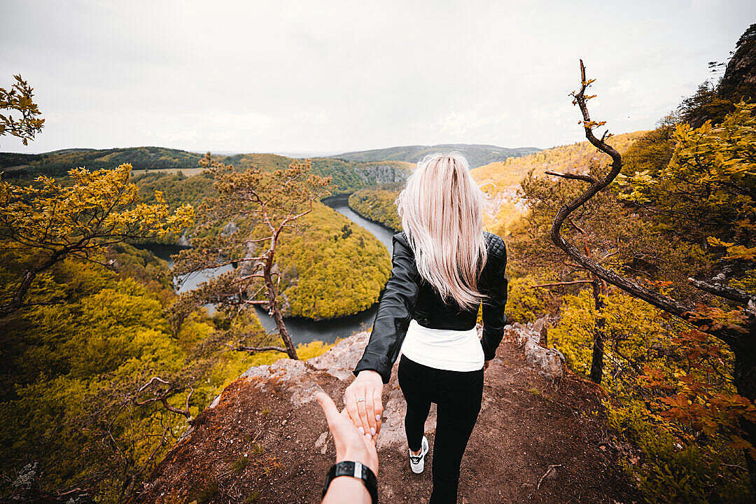 Download Daredevil Couple Exploring a Dangerous Edge of the Rock FREE Stock Photo