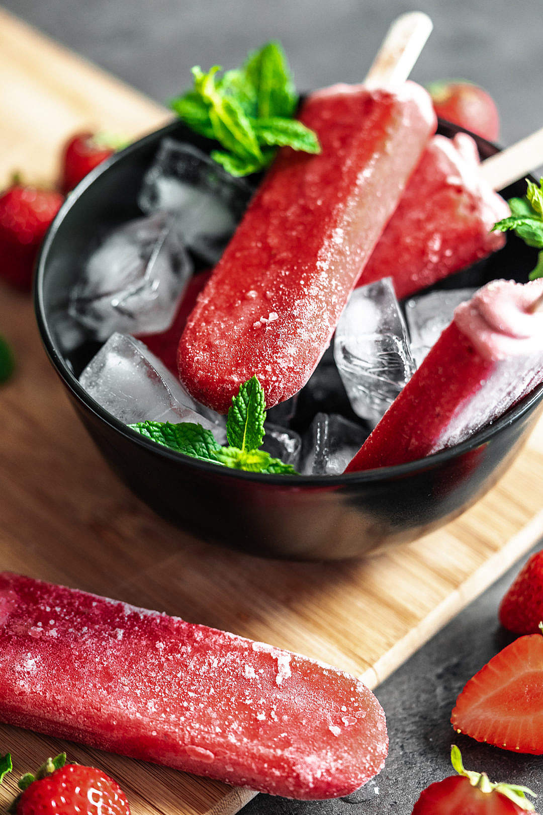 Delicious Strawberry Popsicles on a Wooden Board