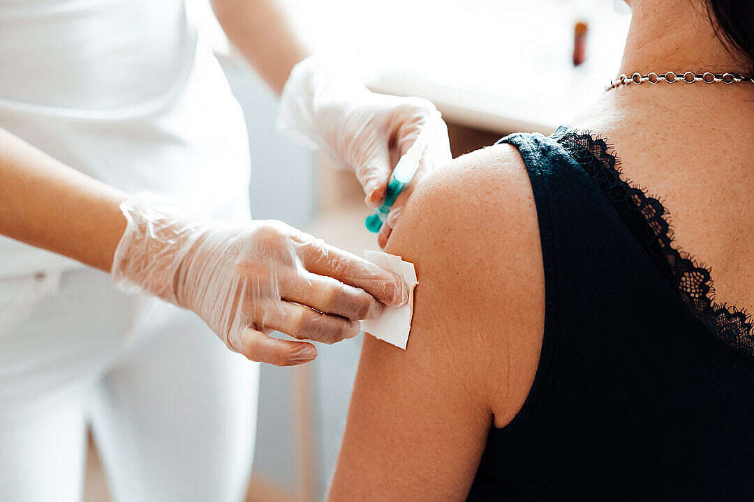 Download Doctor Vaccinating a Patient Against Covid-19 FREE Stock Photo