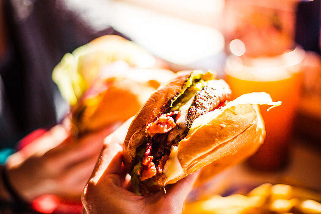 Download Enjoying a Tasty Burger FREE Stock Photo