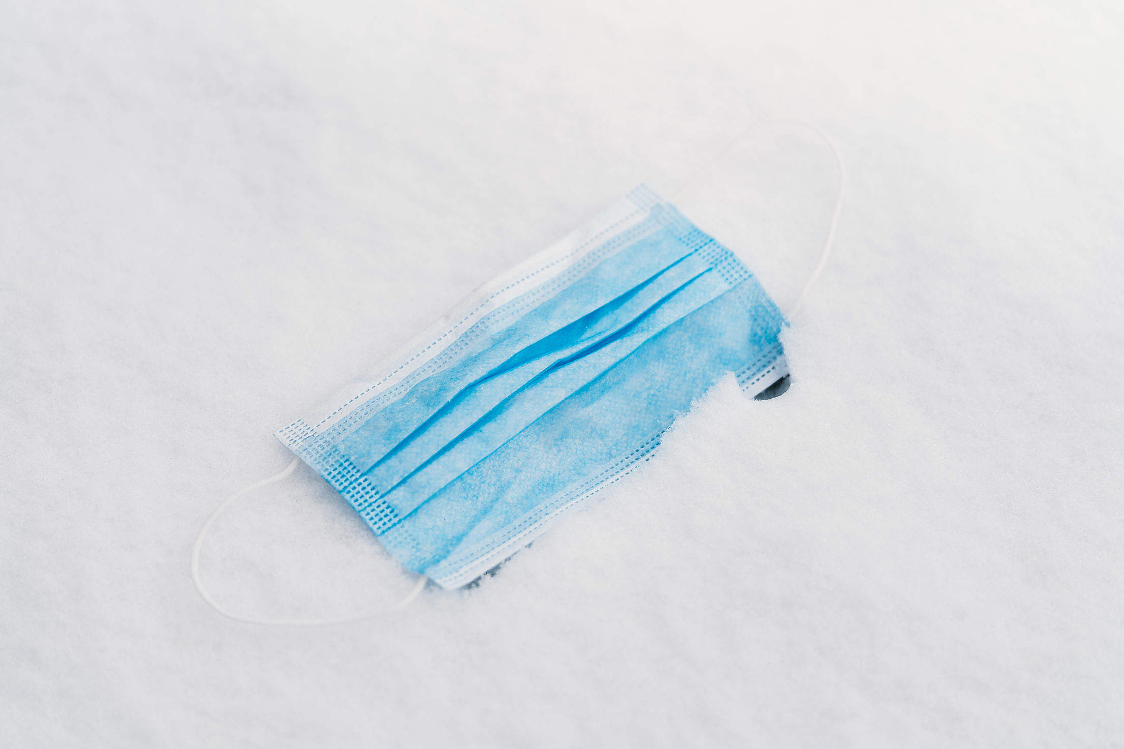 Face Mask Thrown in The Snow Free Stock Photo