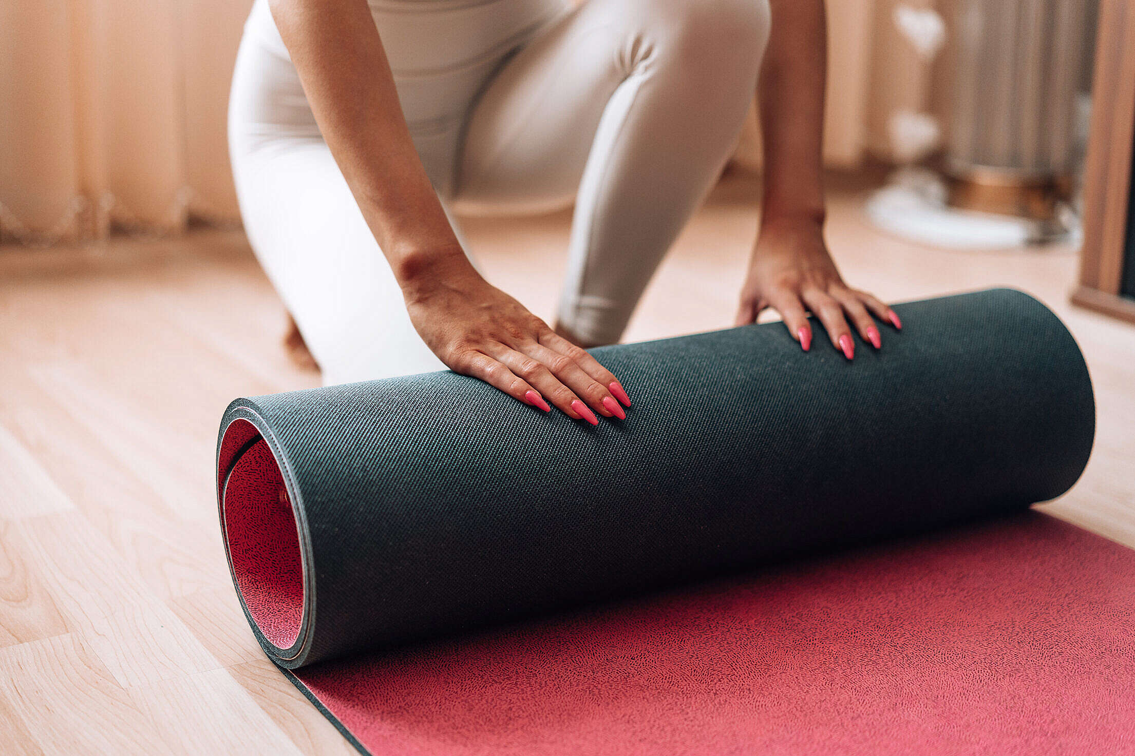 Fit Woman Rolls Her Exercise Yoga Mat at Home Free Stock Photo