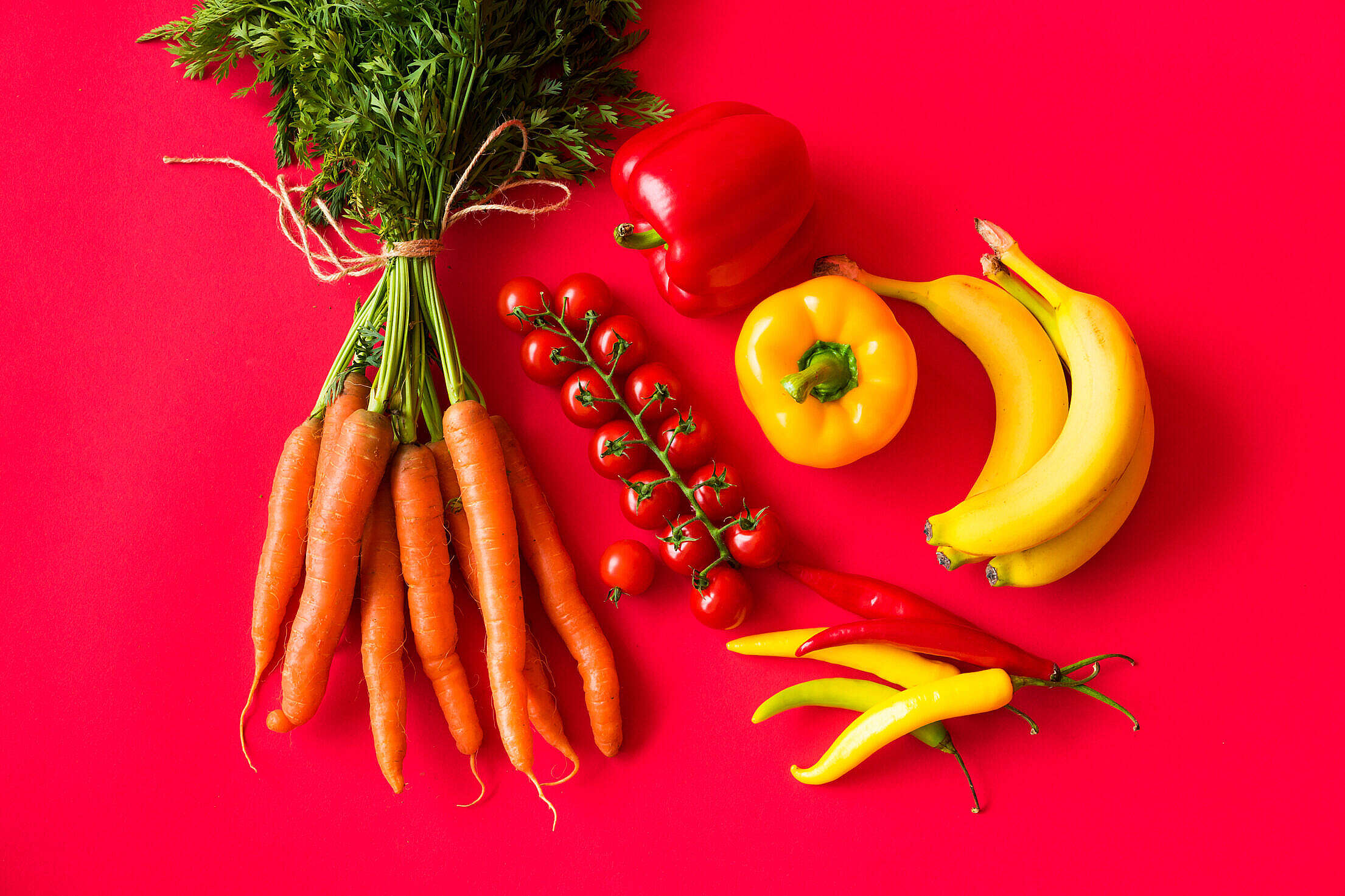 Fresh Fruits and Vegetables on Red Background Still Life Free Stock Photo