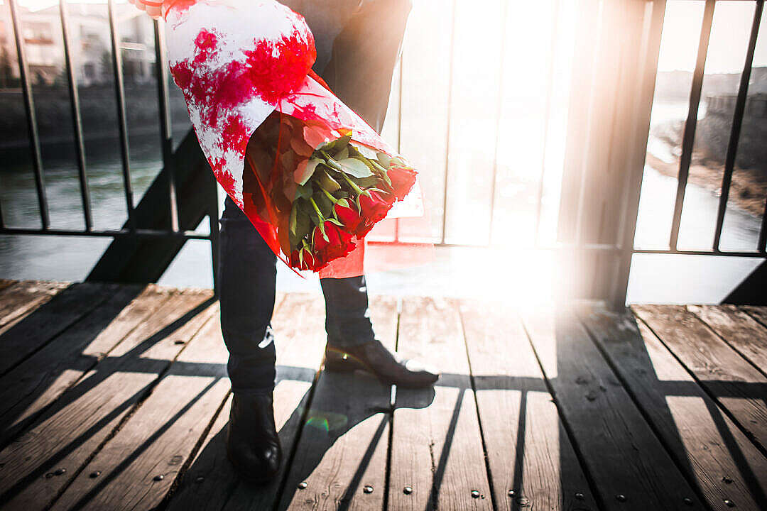 Gentleman with Roses Waiting on a Bridge