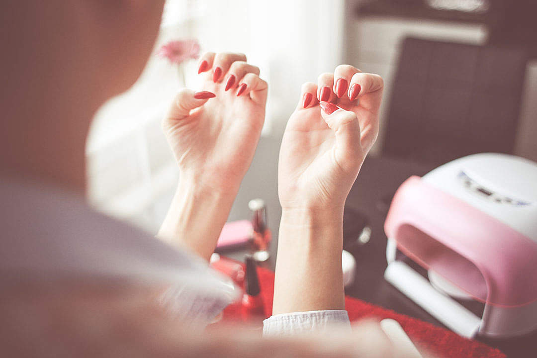 Download Girl Checking her New Nails FREE Stock Photo
