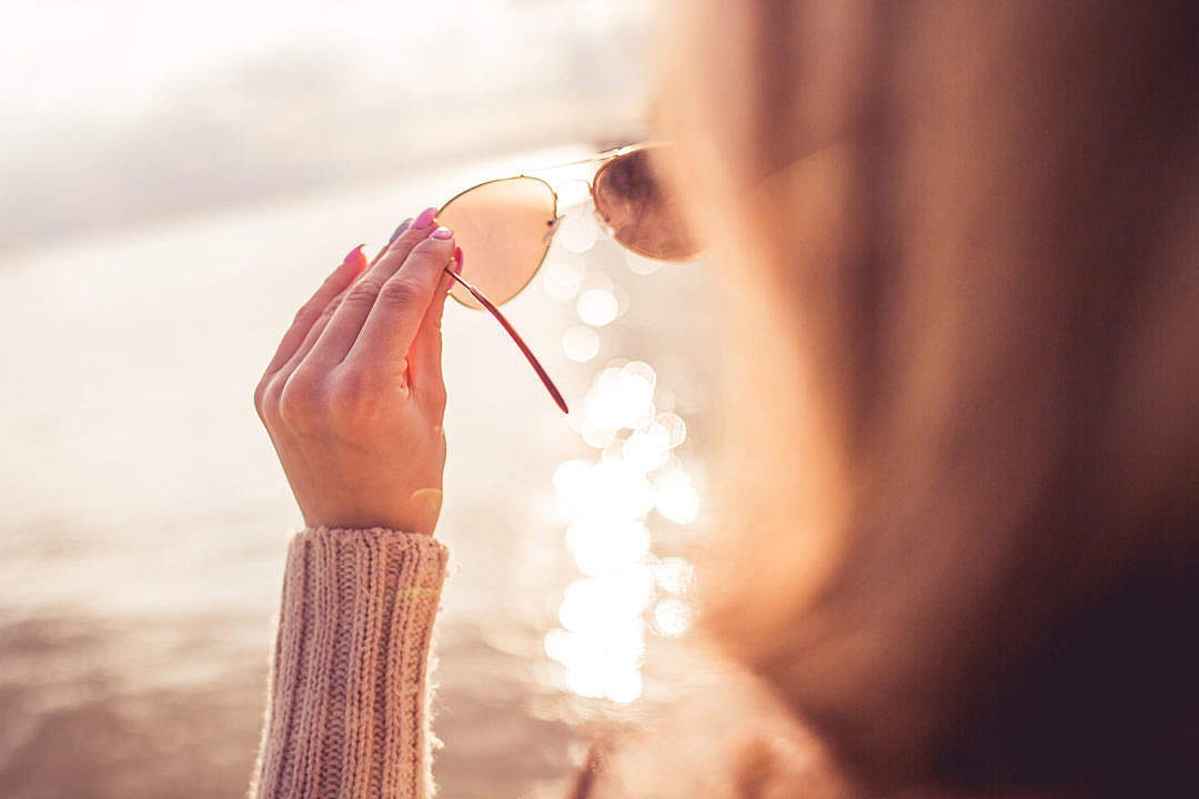 Girl Looking at the Sea Through Sunglasses