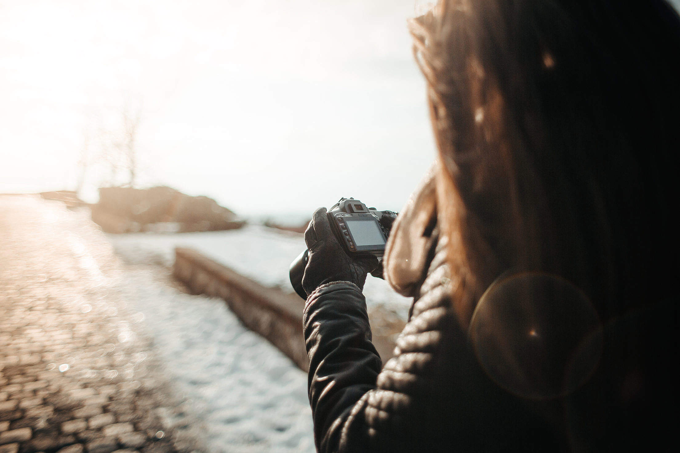 Girl Taking Photographs with her DSLR Free Stock Photo