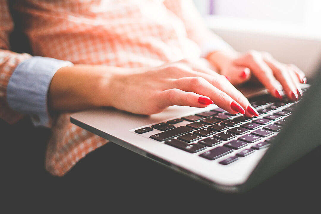 Girl Typing on her MacBook Pro Close Up