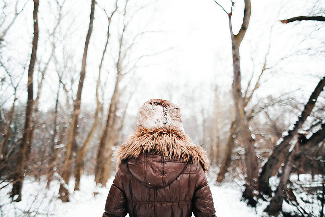 Girl Walking in Snowy Forest