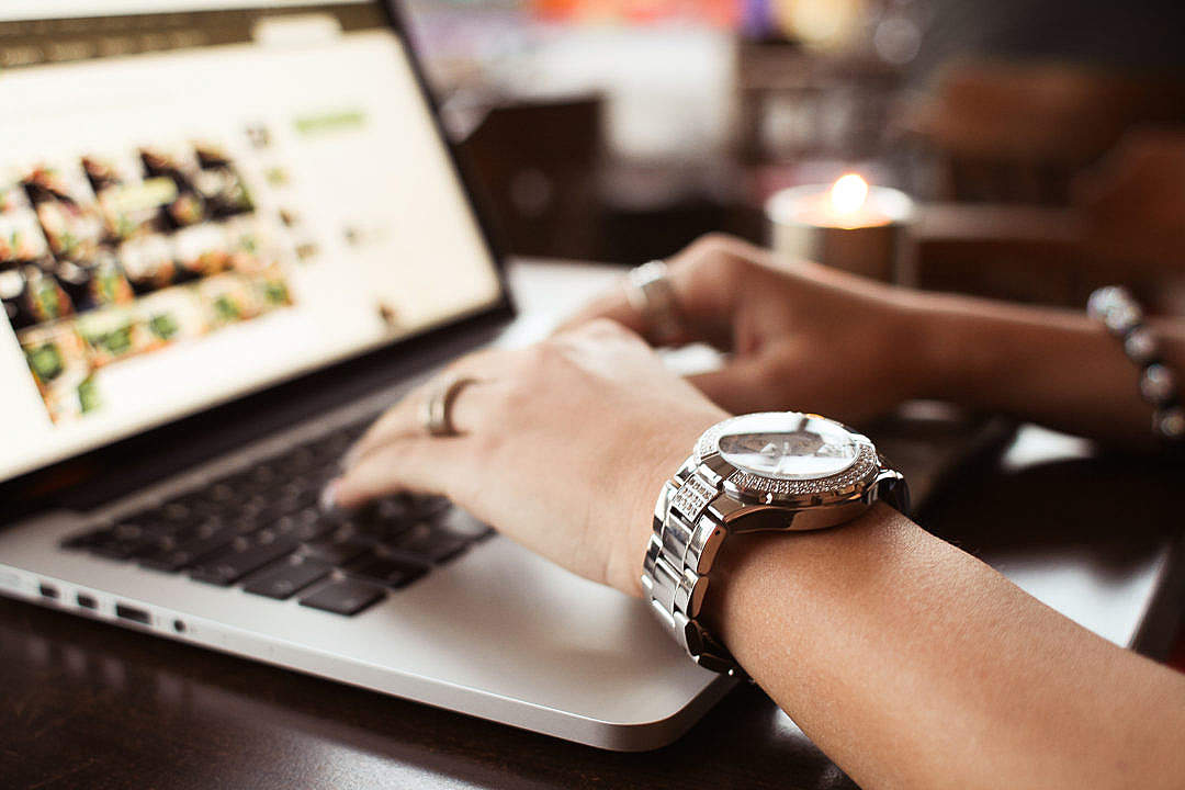 Girl with Watches Typing on MacBook