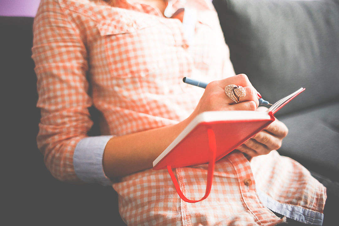 Girl Writing in her Moleskine Diary