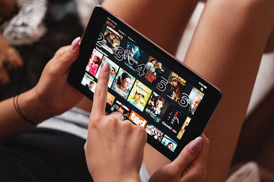 Download Girls Selecting Which Movie to Watch in Netflix App FREE Stock Photo