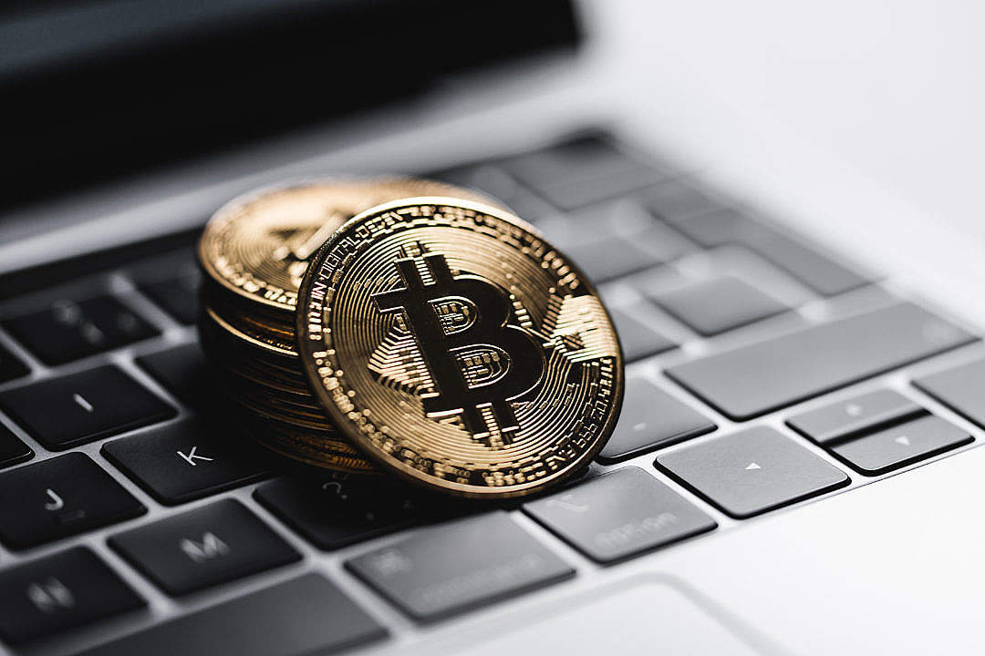 Gold Bitcoin Coins on Laptop Keyboard