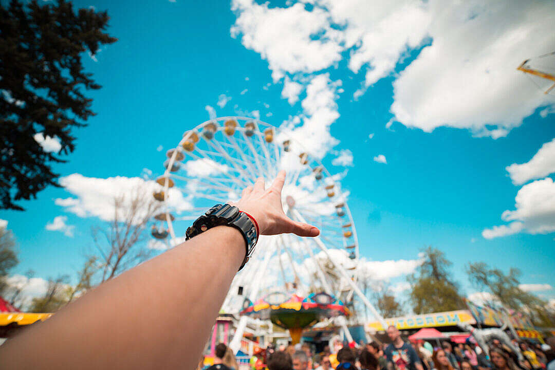 Download Hand Reaching the Ferris Wheel in Amusement Park FREE Stock Photo