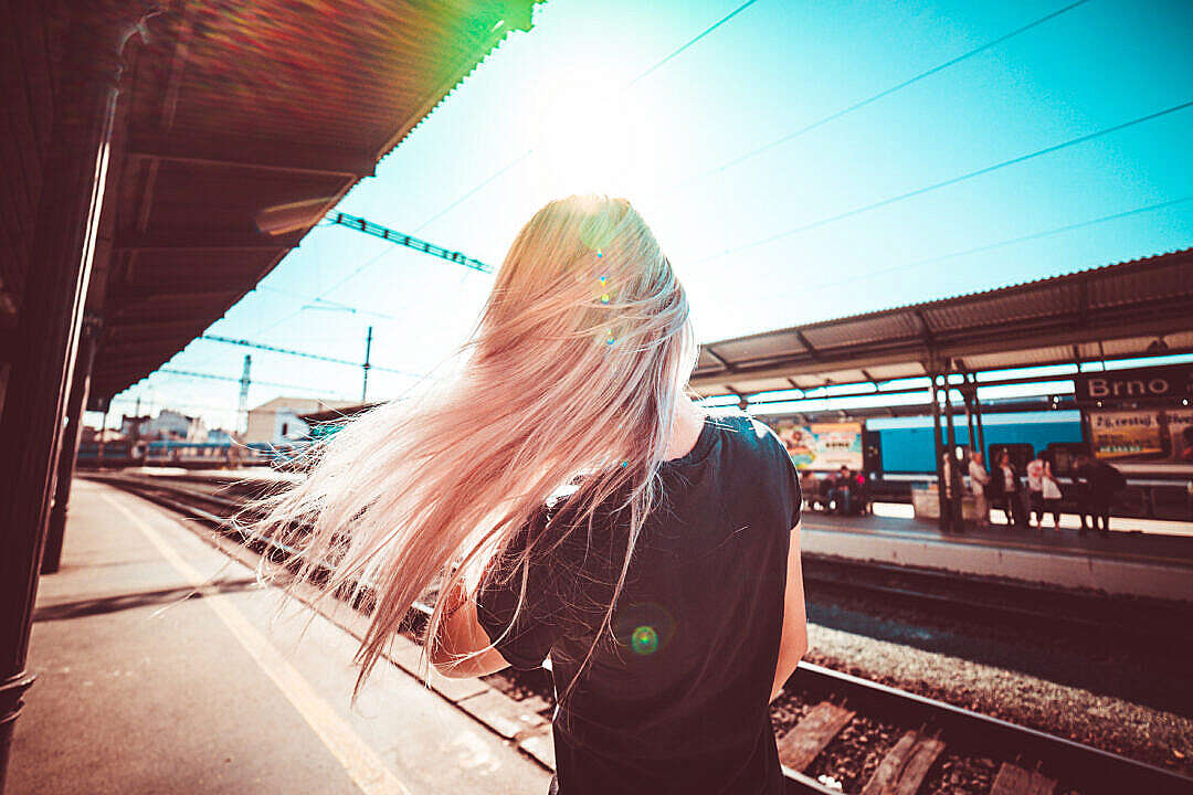 Download Happy Girl Enjoying Free Time & Waiting for Train FREE Stock Photo