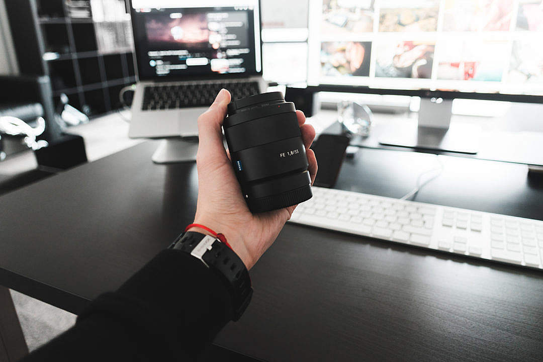 Download Holding Sony Zeiss Sonnar FE 55mm f/1.8 Lens in Hand FREE Stock Photo