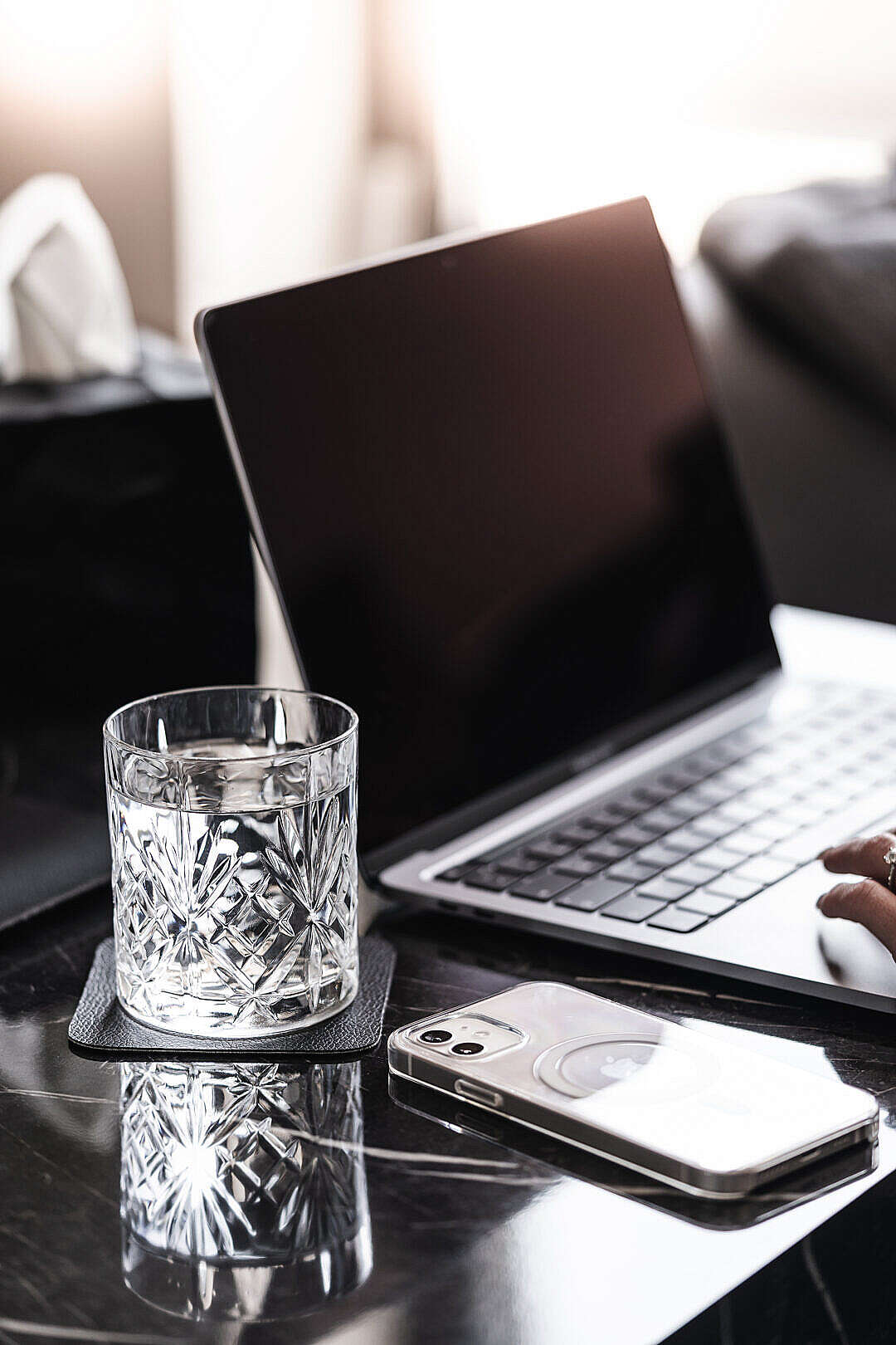 Laptop and Smartphone with a Crystal Glass of Water on a Luxury Marble Table