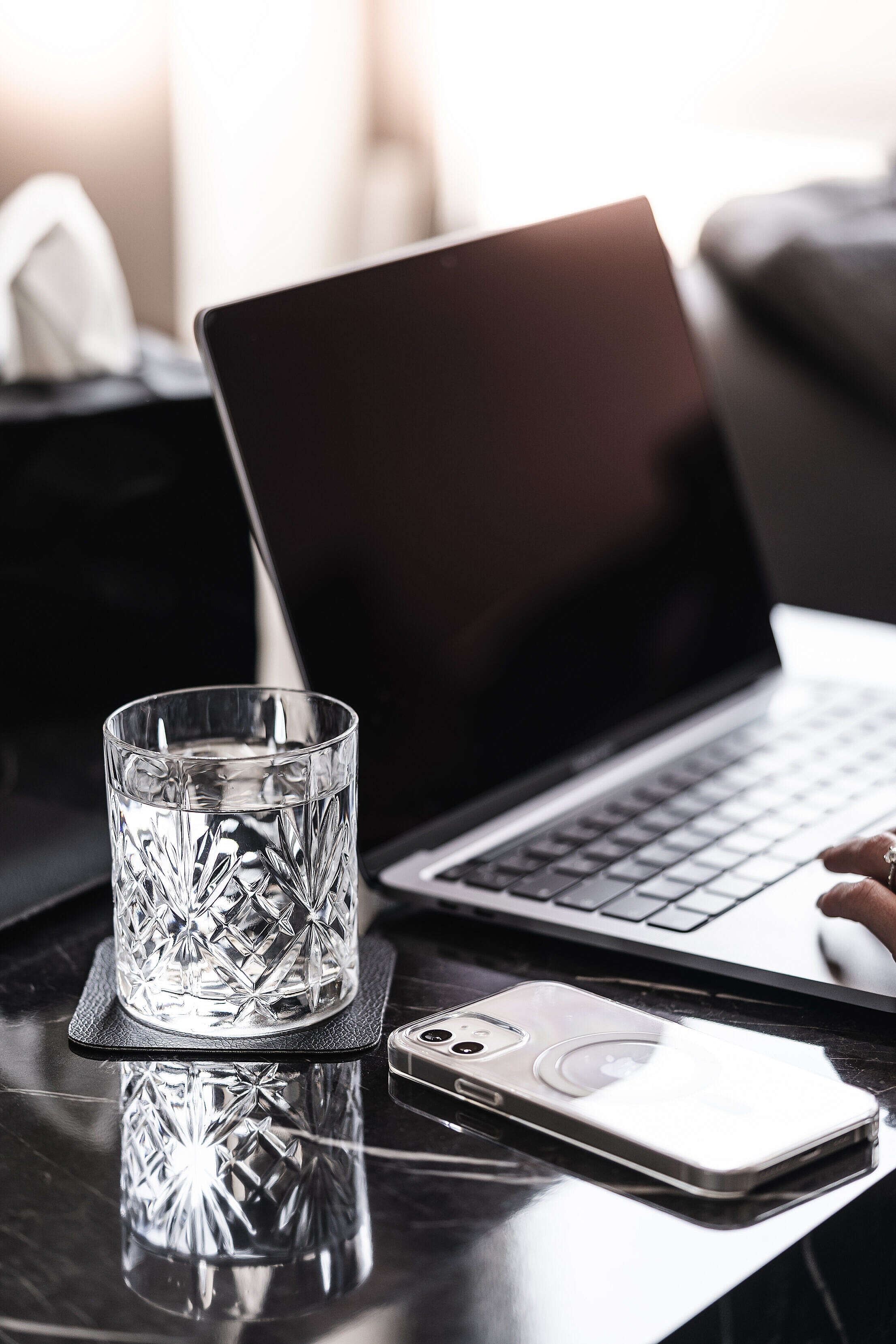 Laptop and Smartphone with a Crystal Glass of Water on a Luxury Marble Table Free Stock Photo