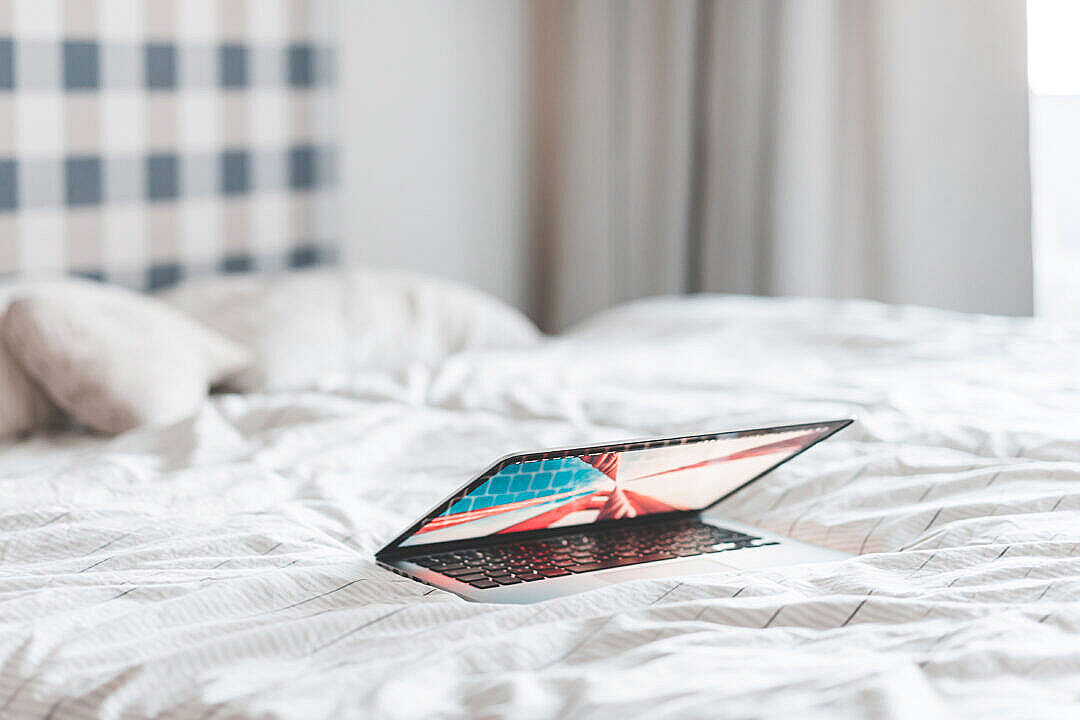 Download Laptop Lying in a Bed FREE Stock Photo