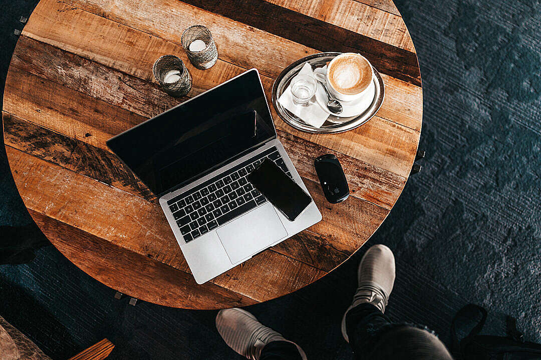 Laptop on a Round Wooden Table Flat Lay