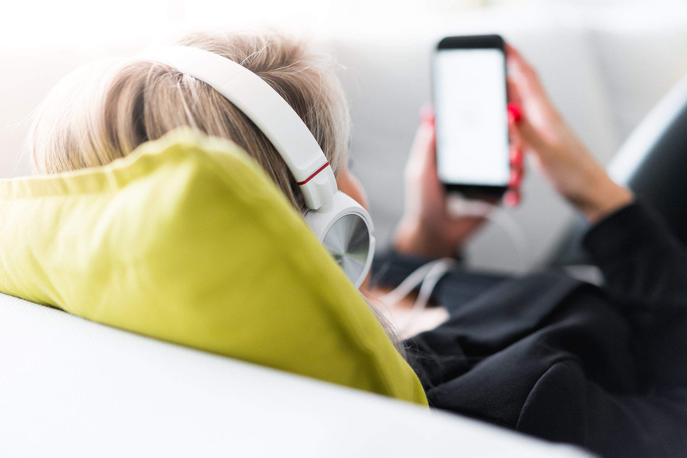 Listening to Streamed Music on iPhone with Headphones Free Stock Photo