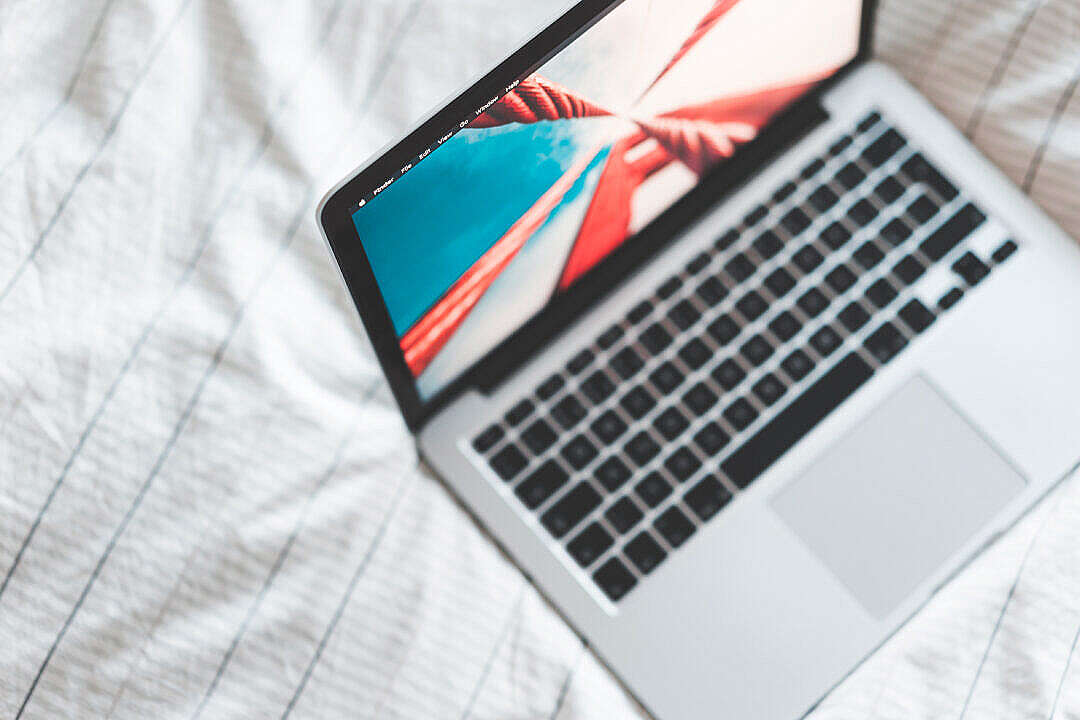 Download MacBook Laptop in Bed from Above FREE Stock Photo