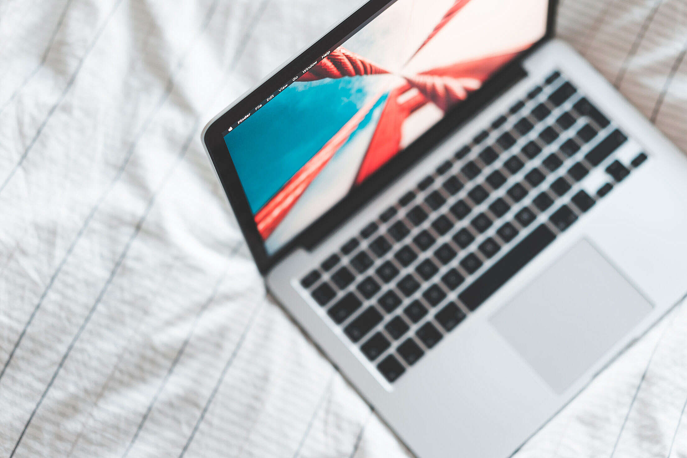 MacBook Laptop in Bed from Above Free Stock Photo