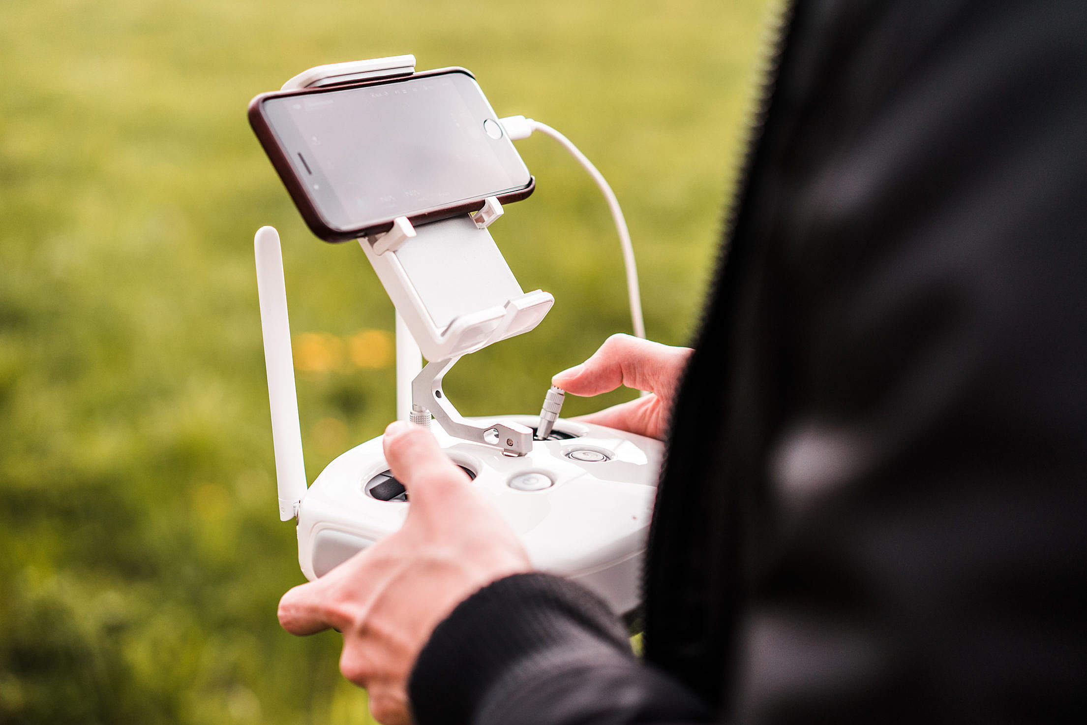 Male Pilot Controlling FPV Drone with Smarphone #2 Free Stock Photo